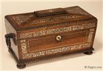 631TC: Tea chest in highly figured rosewood of architectural form by R Dalton of the Bazaar, Soho Square. The chest  is finely inlaid with mother of pearl which depicts stylized flora ; the chest  is standing on turned rosewood feet having turned drop handles. Inside the tea chest there are two liftout hinged canisters (retaining most of their original leading) and a particularly fine cut lead crystal bowl. Circa 1835 