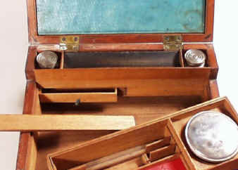 When the tray is lifted, the back panel under the pen tray slides up to reveal two secret drawers.