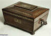 A  Rosewood box in the sarcophagus form.  The box is veneered in figured rosewood and is inlaid in brass depicting stylized flora.  Enlarge Picture