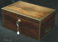  WB483: Regency brass edged  figured rosewood  writing box with brass accents, countersunk brass handles opening to an embossed leather writing surface (replacement) and compartments for pens and inkwells, having compartments for paper under the flaps. There  are secret drawers under the pen compartment concealed behind a sprung flap released by pulling up the wall  of the right inkwell compartment.  The box has two locks. The main one is Bramah and slightly later than the box.  one of the flaps also has a  lock. There is a side drawer for more papers. Circa 1820 Enlarge  picture