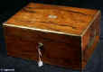 JB418: Early 19th century box veneered in exceptionally strongly figured rosewood. The box is edged in rounded brass and further enhanced with a line of brass stringing and elegant side handles. The inside facings of the box are also enhanced with fine brass stringing. The hinge is most unusual, of a rounded form reminiscent of the Scottish hinge structure. The interior retains its original leather covered tray which has had velvet covers added to the bottom of the sections. A removable velvet cover has also been made for the back lid. Working Bramah lock and key. Circa 1820.  Enlarge Picture