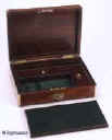 JB309: Brass edged figured rosewood box with hinged lid opening to compartmentalized interior with supplementary lids and liftout tray 1830. Enlarge Picture