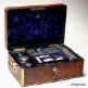 JB316: Brass edged flame mahogany fully fitted dressing box with inset brass handles and Bramah lock opening to a leather covered lift out tray with cut glass bottles with hallmarked silver tops (1827-9) a document wallet in the lid. Circa 1830. Enlarge Picture