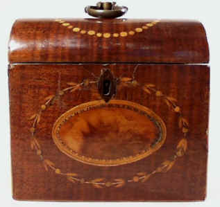 A single tea Georgian caddy in harewood with an oval medallion of a distinctively figured wood fragment, framed by a formal design of delicate foliage, suggesting the Grecian laurel or myrtle wreath.