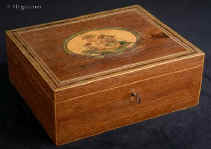 SB 493: A rare Georgian sewing box of rectangular form  edged with maple the top having a hand colored print depicting cherubs and framed with mitered purfling having a lift-out tray still retaining turned Tunbridge ware whitewood sewing tools. Circa 1800. Enlarge Picture